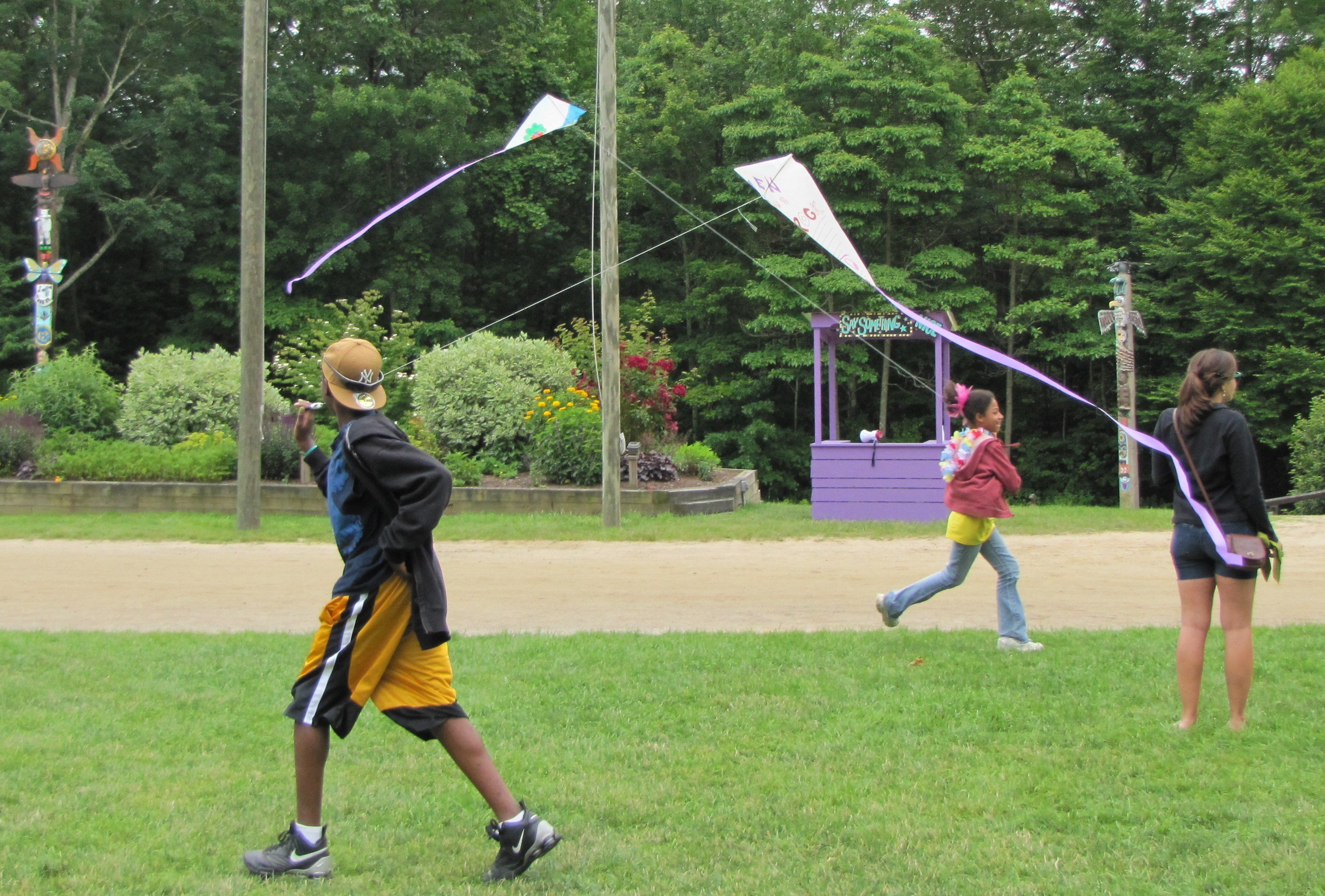 Kids flying kites at camp.